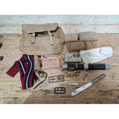 106 - A box of militaria to include headphones, various related items, whistles, scope, a William Rodgers ... 