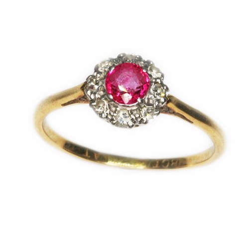 62 - A diamond and ruby cluster ring, the cluster measuring approx. 8mm in diameter, band marked '18ct PL... 