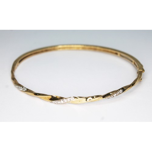 72 - A hallmarked 9ct gold diamond bangle, diameter approx. 5.5cm, wt. 8.2g.