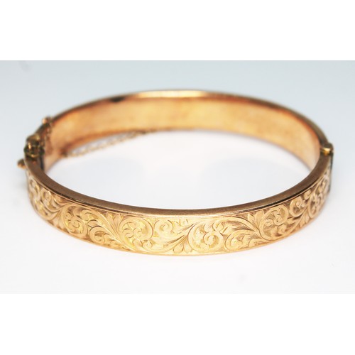 76 - A hallmarked 9ct gold bangle, also marked 'Wax Filled', gross wt. 17.2g.