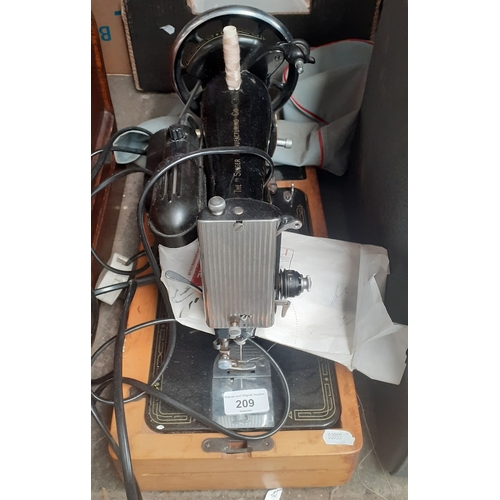 209 - A Singer electric sewing machine with pedal etc