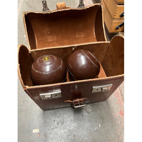 72 - Two sets of crown green bowls in a leather carry case