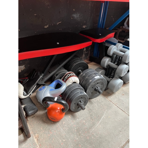 124 - A weightlifting bench together with weights and boxing gloves.