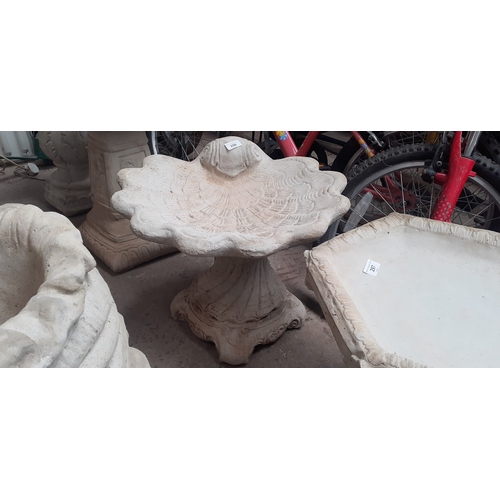 298 - A shell shaped bird bath on plinth