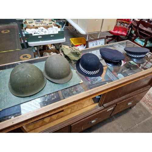 162 - Various helmets including American and police hats.