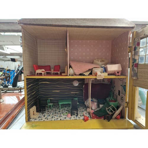 335 - A dollshouse and a box of furniture.