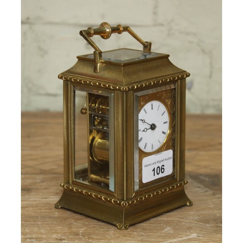 106 - A late 19th century brass repeat carriage clock, etched brass with round enamel dial having Roman nu... 