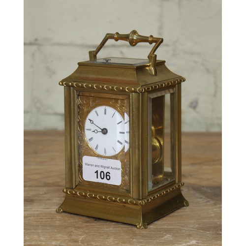 106 - A late 19th century brass repeat carriage clock, etched brass with round enamel dial having Roman nu... 