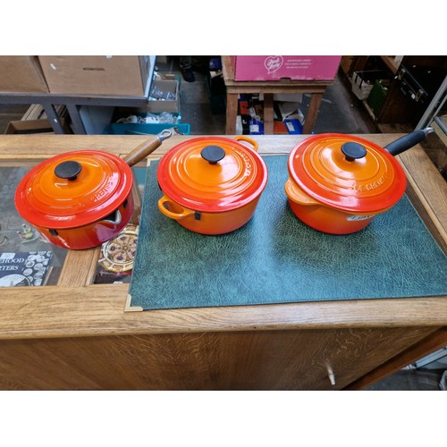 75 - Three Le Creuset volcano orange cooking pans