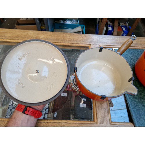 75 - Three Le Creuset volcano orange cooking pans