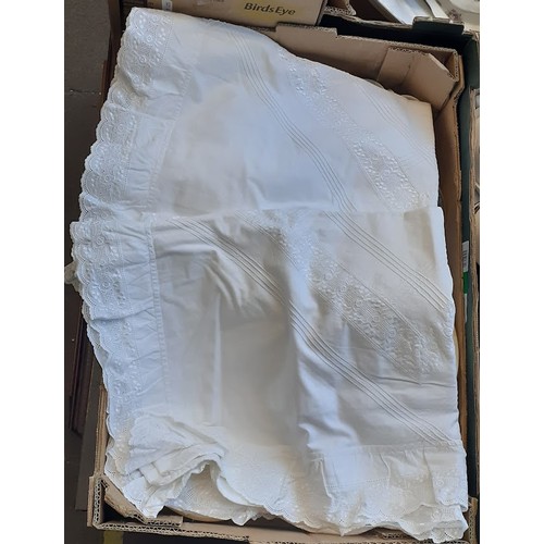 394 - A box of christening gowns and linen.