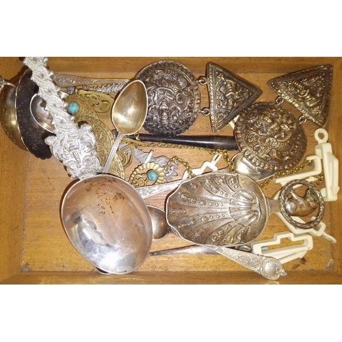 447 - A wooden box containing eastern white metal spoons and jewellery.