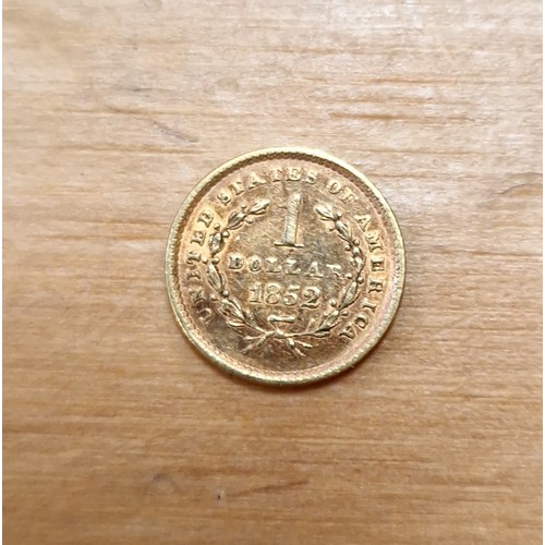 455 - An American liberty head gold dollar coin, dated 1852, weight 1.7g.