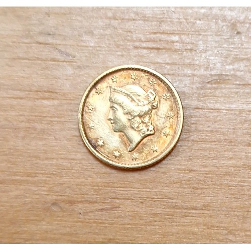 455 - An American liberty head gold dollar coin, dated 1852, weight 1.7g.