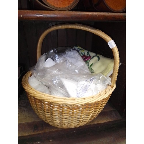 79 - A basket of assorted linen and needleworks.