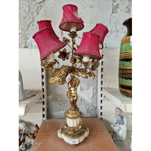 550 - A late 19th century gilt metal and marble four branch candelabra converted to electric, height 69cm.