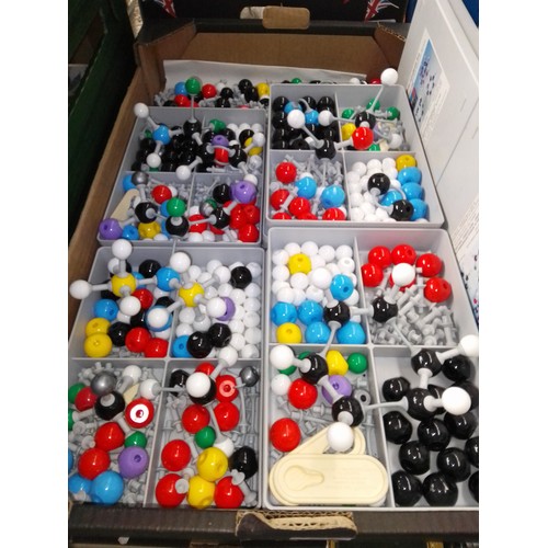 253 - A box of molecular model parts.