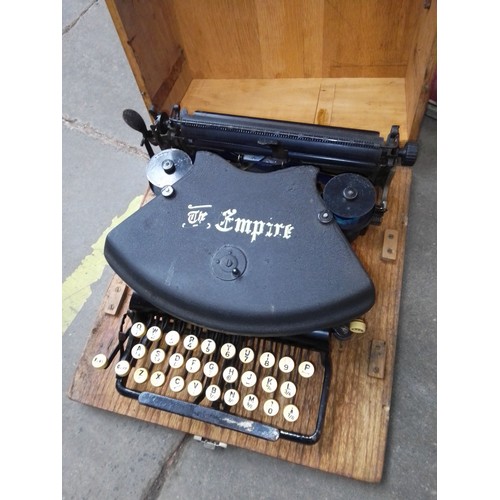 264 - A vintage Empire typewriter in a wooden case