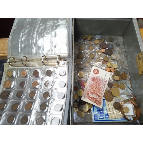 292 - A tin of assorted coins.