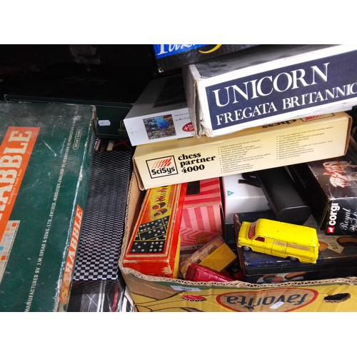 300 - A box of toys etc to include electronic chess, ship construction kit, jigsaw, playworn toy cars, dom... 