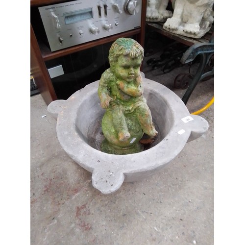 350 - A circular concrete planter and a garden cherub figure - as found