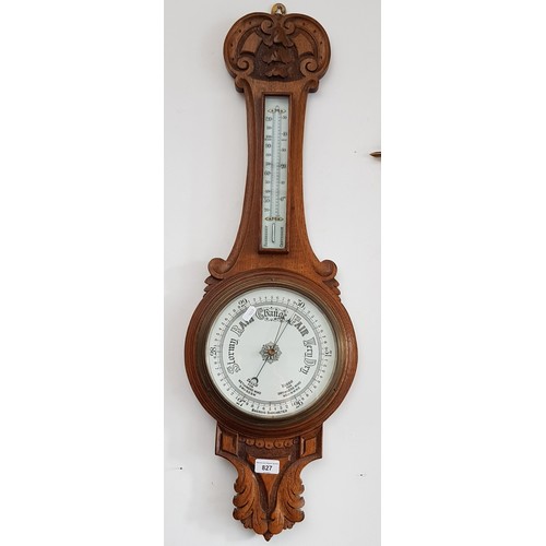 827 - A carved oak aneroid barometer.