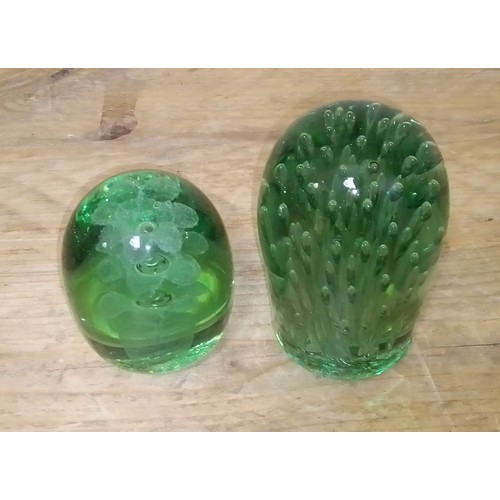 69 - Two green glass dumps, height 11cm & 14cm.