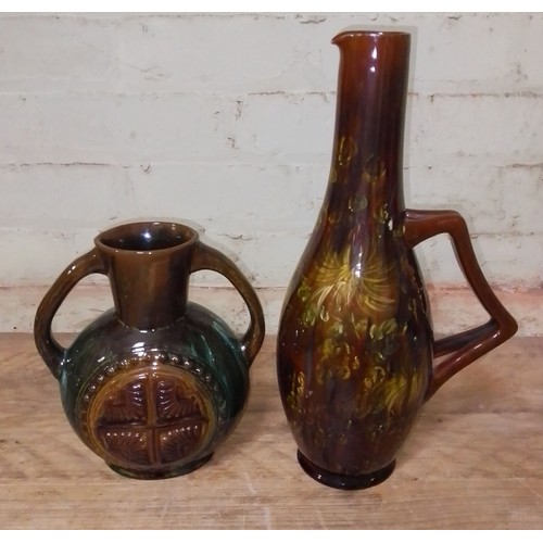 71 - Two Linthorpe pottery jugs in the manner of Christopher Dresser, height19.5cm & 34cm.