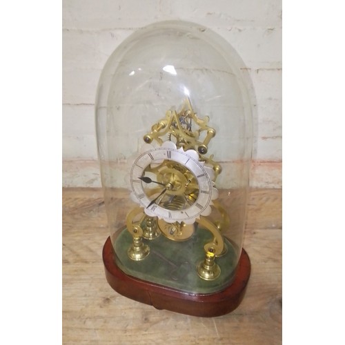 81 - A skeleton fusee clock with pendulum and key, under glass dome, height 39cm.