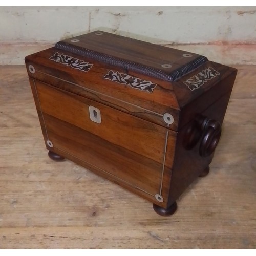 86 - A Regency mother of pearl inlaid rosewood tea caddy of sarcophagus form, length 21.5cm.