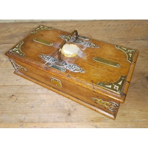 84 - A brass mounted oak cigarette and cigar box with carry handle, length 30cm.