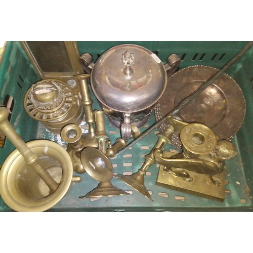 113 - A box of assorted metal ware including a winged brass sphinx, an elongated cast figure, candlesticks... 