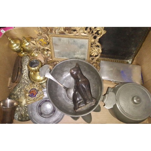 119 - A box of assorted metal ware including a bronze cat, a cast framed mirror, etc. etc.