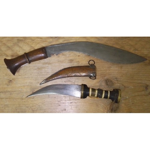 145 - A Middle Eastern jambiya dagger in wood and copper sheath together with a Kukri knife.