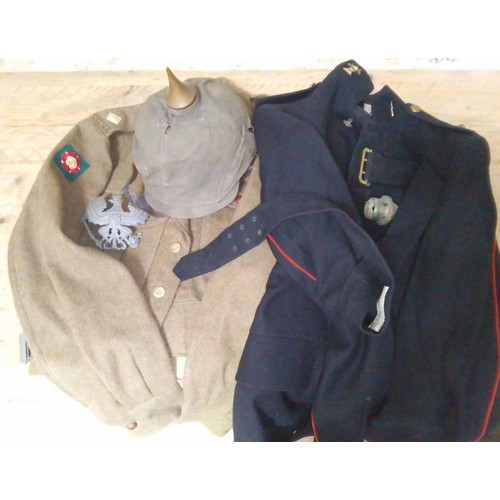 142 - A 12th Royal Lancers uniform jacket, dated 1950 together with a battledress blouse / tunic, pattern ... 