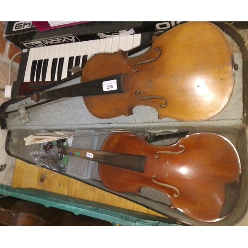 238 - Two 3/4 size violins, with one case and a bow.