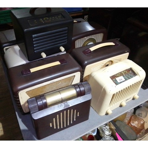 214 - A collection of nine small bakelite radios.