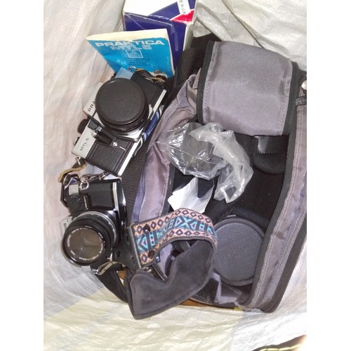 278 - A bag of assorted cameras and accessories including an Olympus OM10 and a Praktica MTL5, various len... 