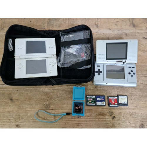 442 - Two Nintendo DS portable games consoles with a few games and case.