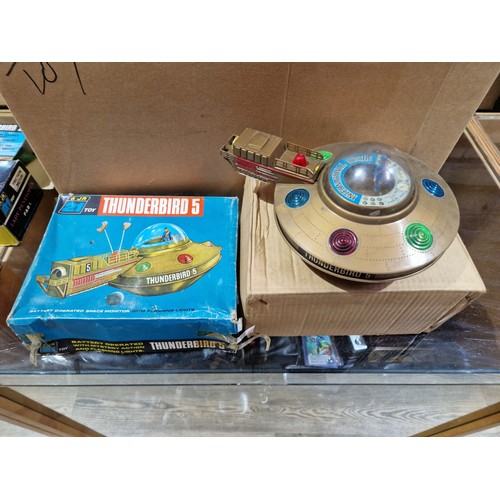 327 - A box of vintage toys including AJR 21 Thunderbird toys.