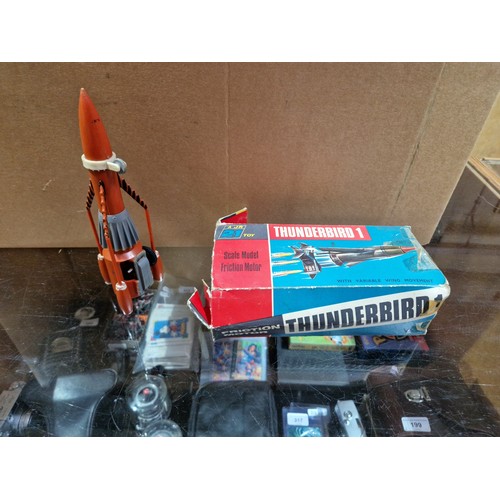 327 - A box of vintage toys including AJR 21 Thunderbird toys.