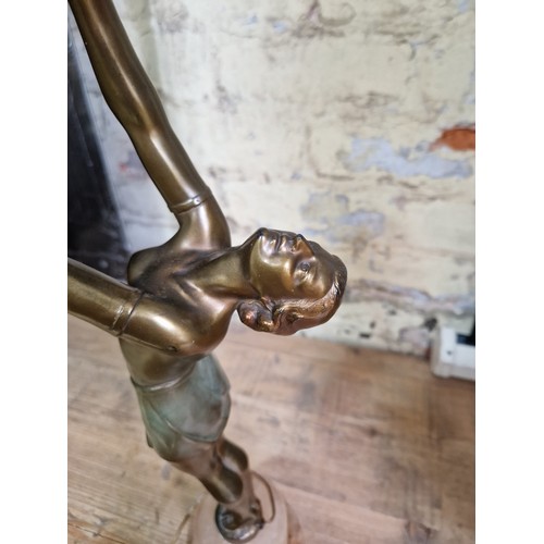 79 - An Art Deco gilt spelter lamp modelled as a semi nude female figure on alabaster base, height 55cm.