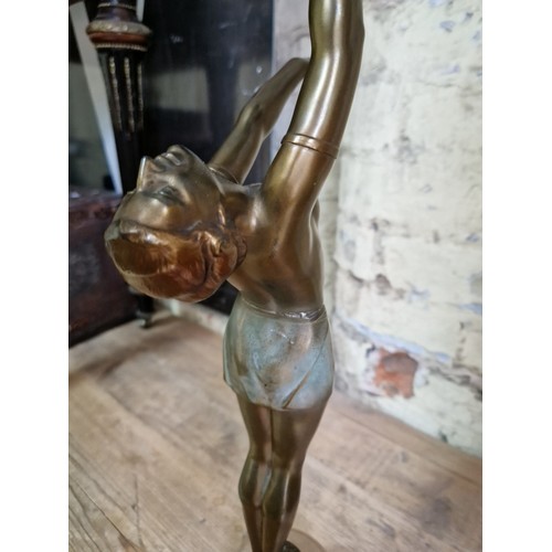 79 - An Art Deco gilt spelter lamp modelled as a semi nude female figure on alabaster base, height 55cm.