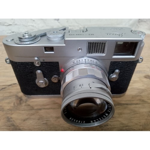 178 - A Leica M2 35mm camera, circa 1963, serial no. 1086329, with Summicron 1:2/50 lens and leather case.