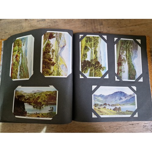 274 - Two albums of postcards, early 20th century, various subject matter, including Lake District etc., e... 