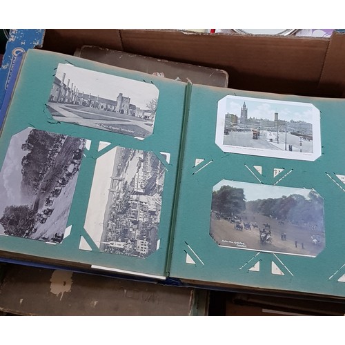 272 - A box of early 20th century postcards albums.