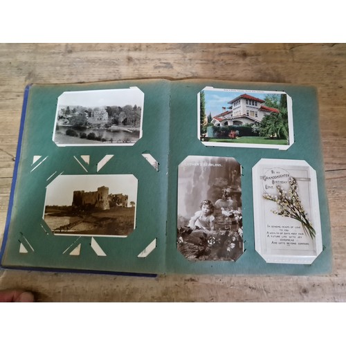 272 - A box of early 20th century postcards albums.