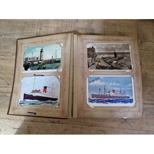 272 - A box of early 20th century postcards albums.