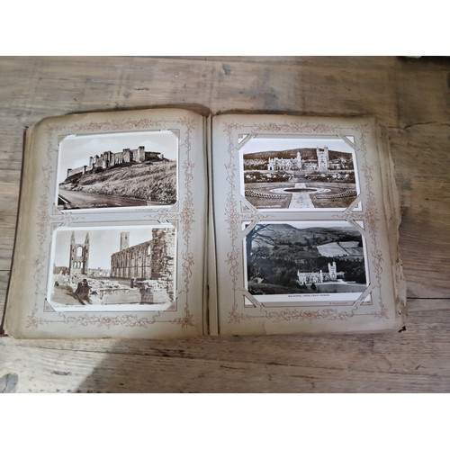 272 - A box of early 20th century postcards albums.