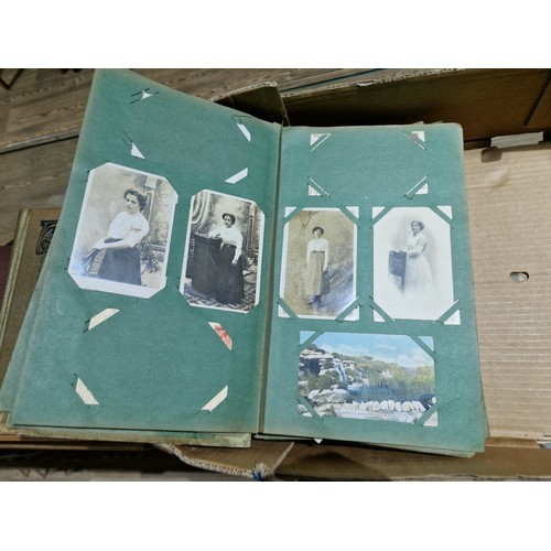 272 - A box of early 20th century postcards albums.